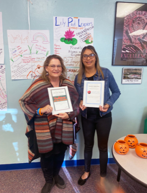 Teacher of the month, Christine next to employee of the month, Denisse.