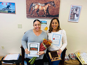 Teacher of the month, Anna next to employee of the month, Dulce.
