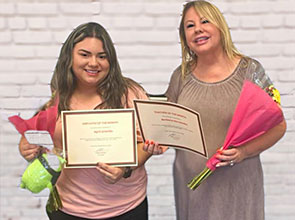 Barbara Hernandez and April Granillo holding their awards