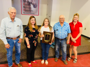 2021-2022 Teacher of the Year Kimberly Franklin holding plaque while surrounded by others.