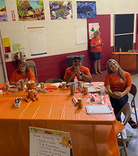 Teachers sitting at a team table for an event