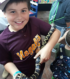 Student holding a snake