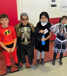 Four students in costume for Halloween