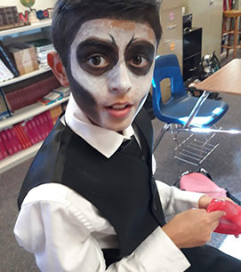 Student in a skeleton groom costume with face paint
